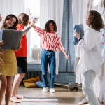 Students signing and dancing in dorm room