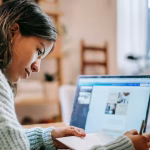 Lady studying at open laptop