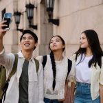 Three smiling students take a selfie
