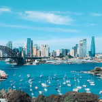 Cityscape with skyscrapers and harbour with boats and bridge