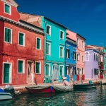 Colourful houses next to a canal with boats