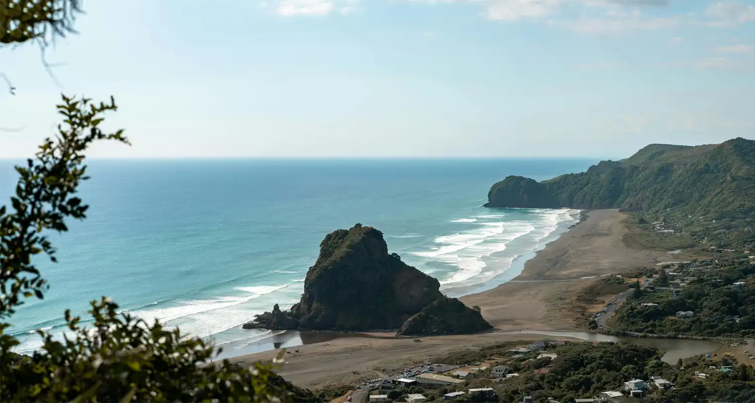 Beach with white waves around large rocks