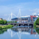 Image of a river with a football stadium in the background