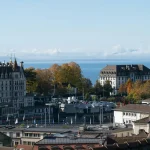 Image of buildings with the view of a lake in the background