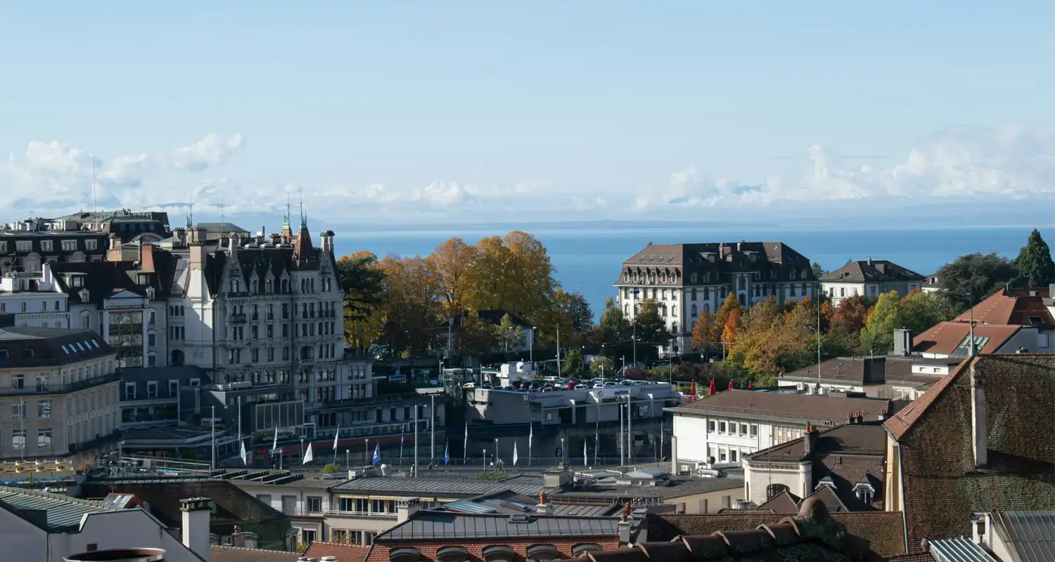 Image of buildings with the view of a lake in the background