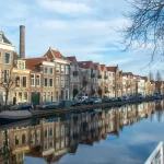 Image of a canal with houses next to it