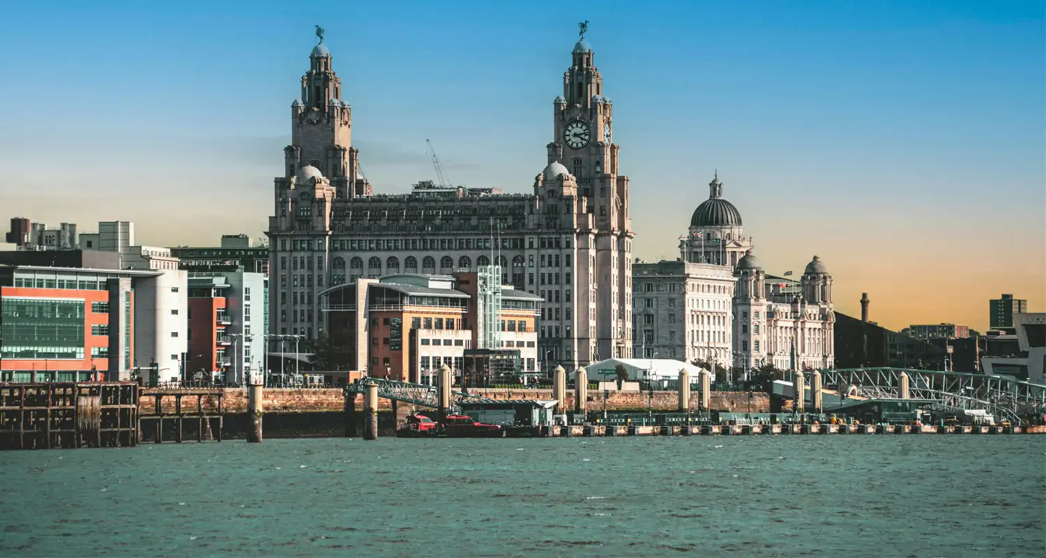 Image of a river with some large buildings behind it