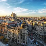 Image of large light stone buildings with elaborate rooves