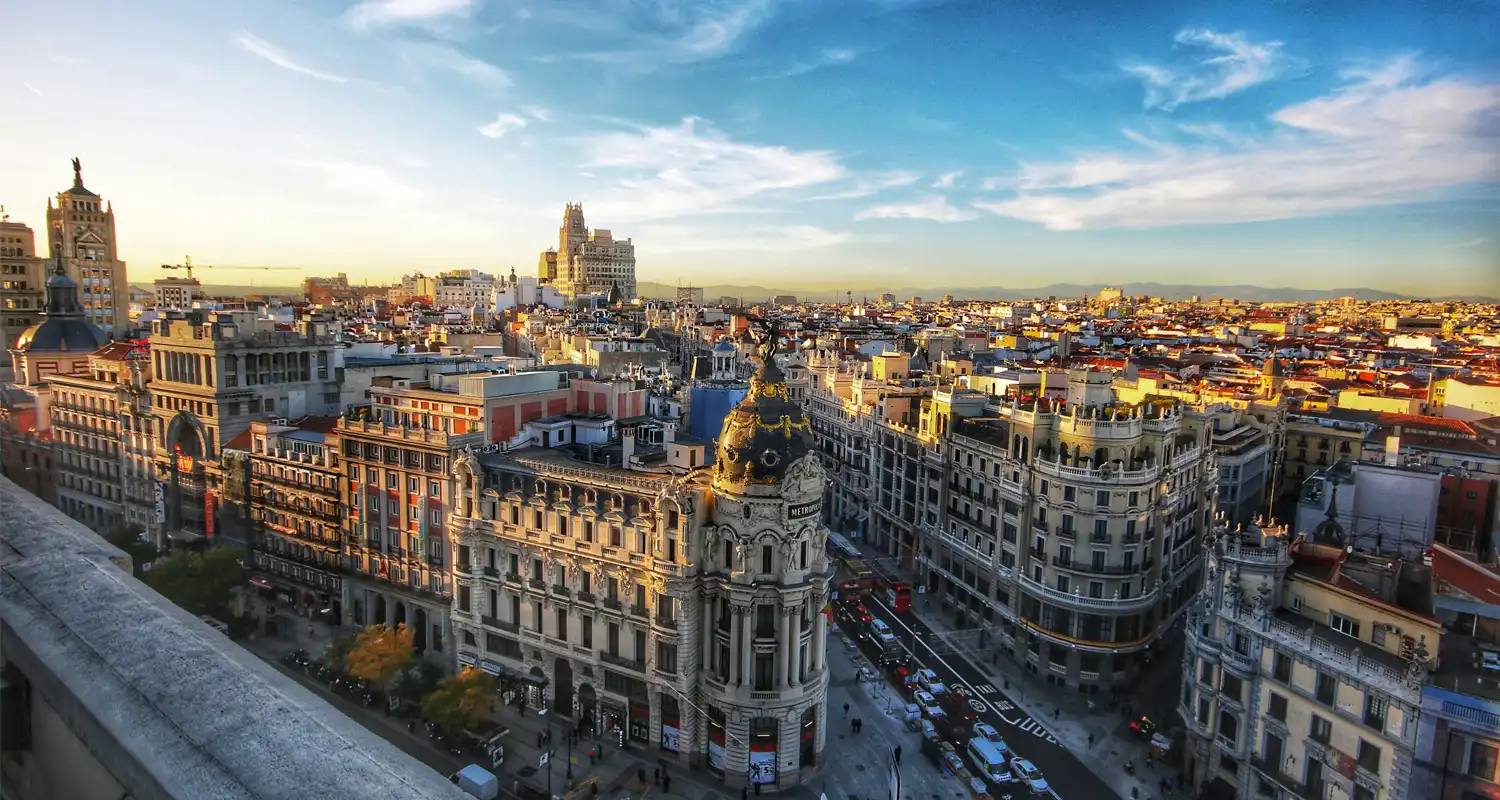 Image of large light stone buildings with elaborate rooves