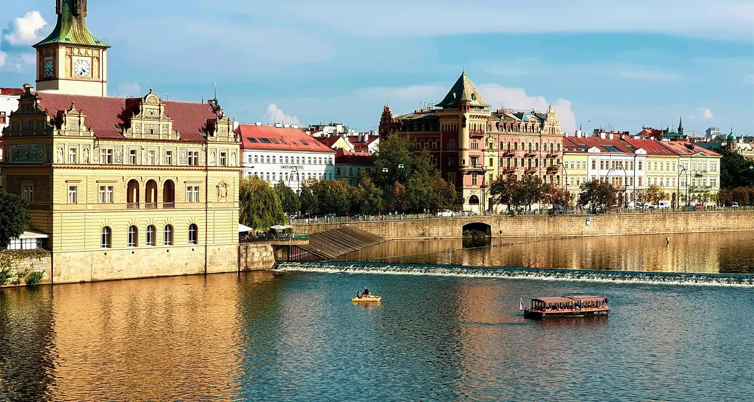 Building next to a river with the sun shining on it