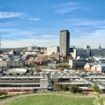 Image of a city skyline with a large skyscraper in the centre