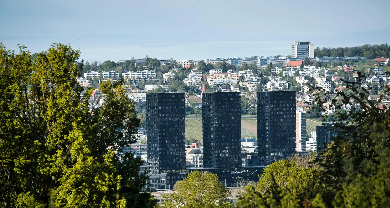 City skyline with modern buildings and trees in the foreground