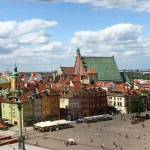 Image of a city skyline with red brick buildings and elaborate architecture