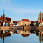 Image of several buildings next to a body of water