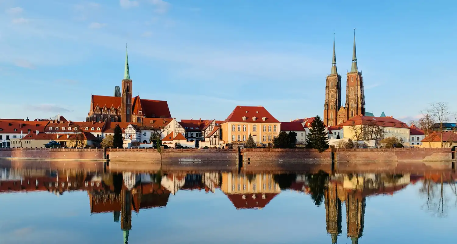 Image of several buildings next to a body of water