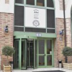 Image of a building with a door and large windows