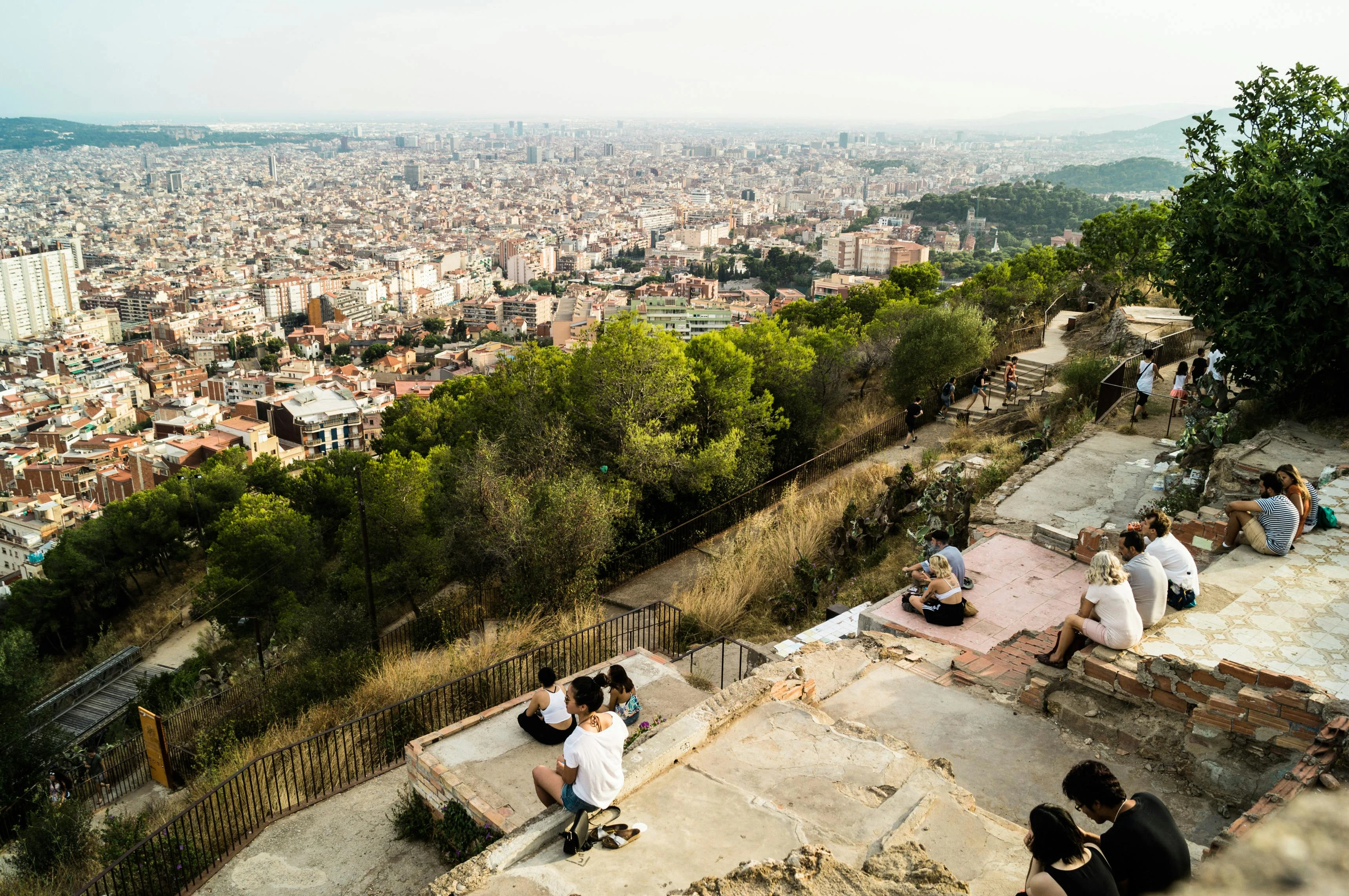 People on a hill overlooking a large city