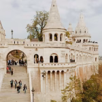 People walking around an ancient castle