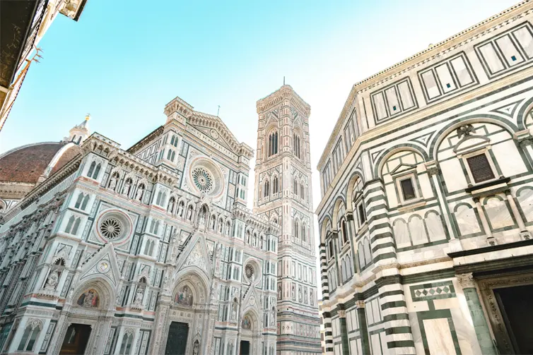 Large white buildings with intricate black designs, shot from below.