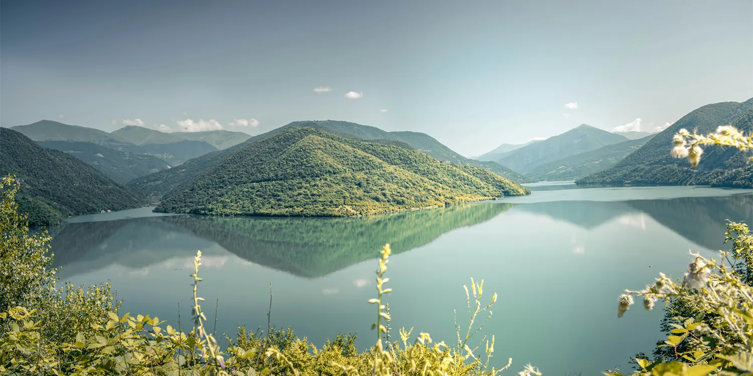 Tree covered mountains with a large lake below them