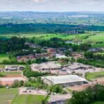 Birds eye image of green fields with Hartpury University campus buildings