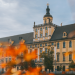 Image of a large building with bright flowers in front of it