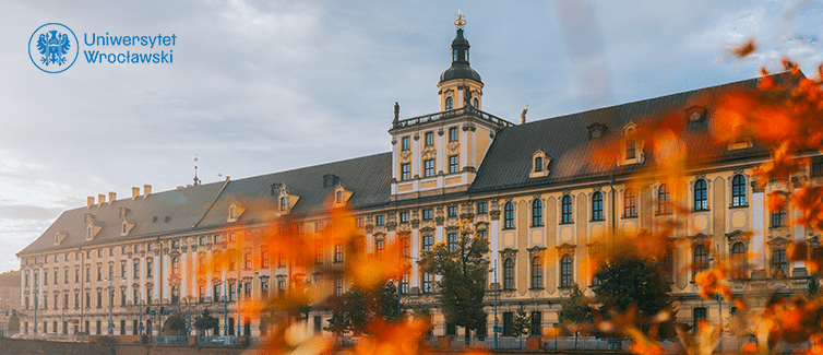 Image of a large building with bright flowers in front of it