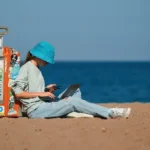 Lady reading a book on a beach