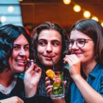 Students sharing a drink with drinking straws