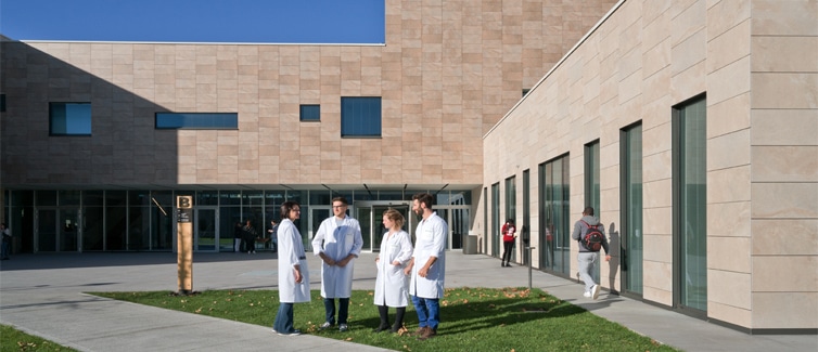 Image of students outside of a modern sandstone building