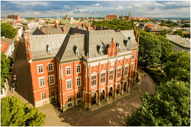 Large red brick building surrounded by trees