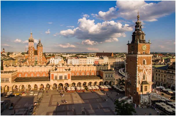 City square surrounded by red brick buildings and a tall clock tower