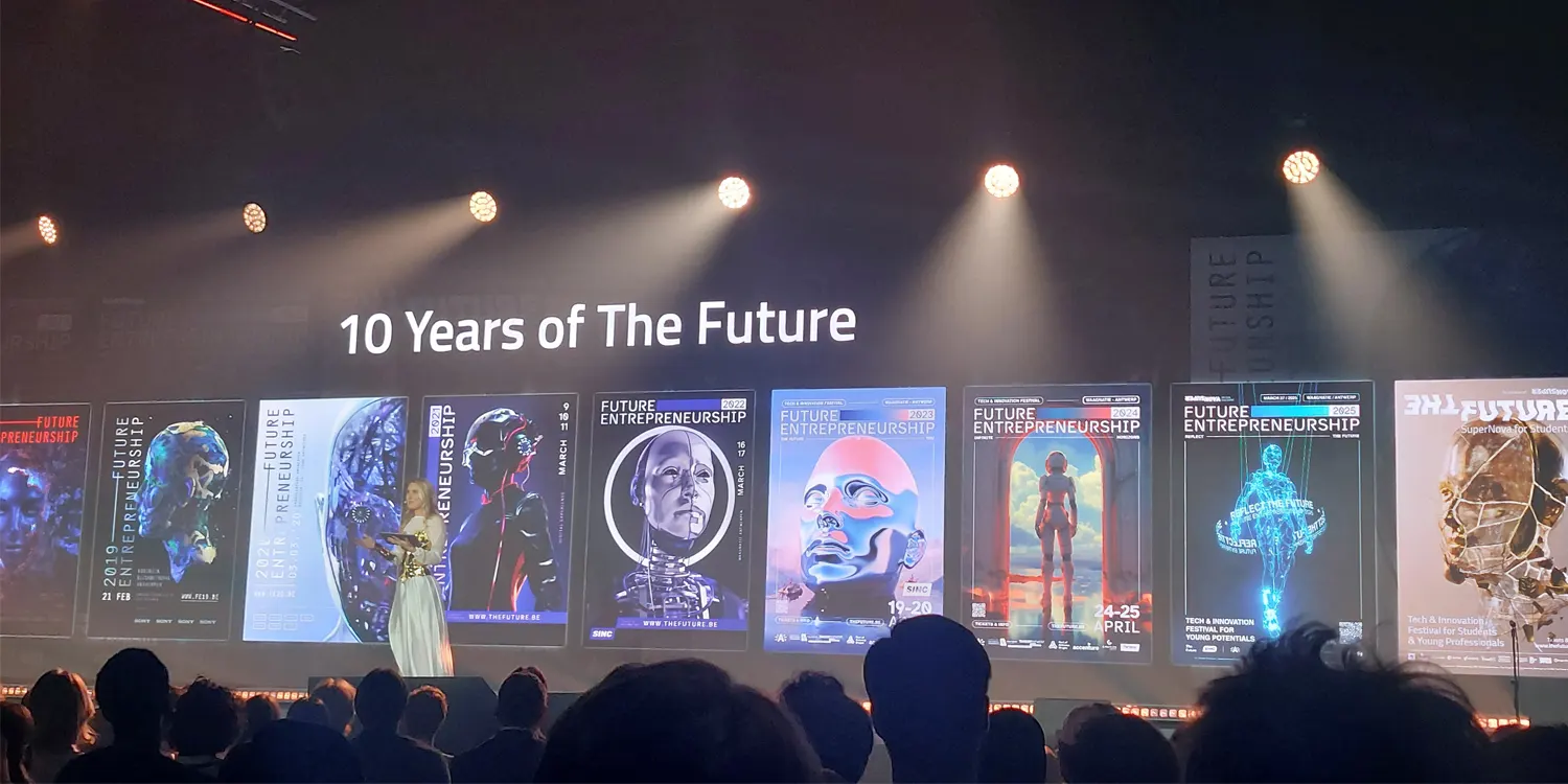 A person on stage with a presentation behind them