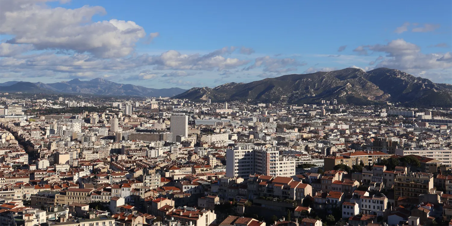 A city skyline with a mountain in the background