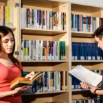 Two people reading books in a library