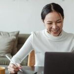 Smiling lady working on laptop