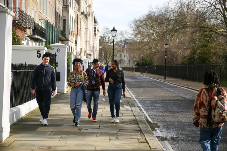 Students walking down a street talking to each other