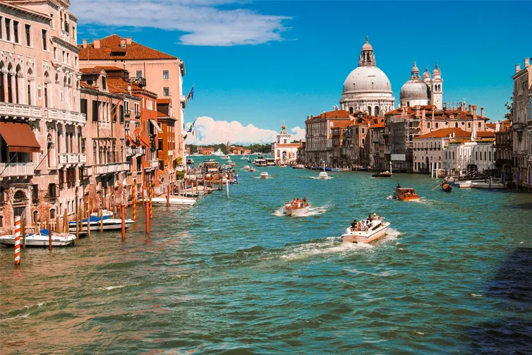 River with boats on it and buildings either side.