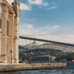 A historic mosque building next to a road bridge over a body of water