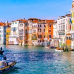 Colourful buildings on the side of a canal.