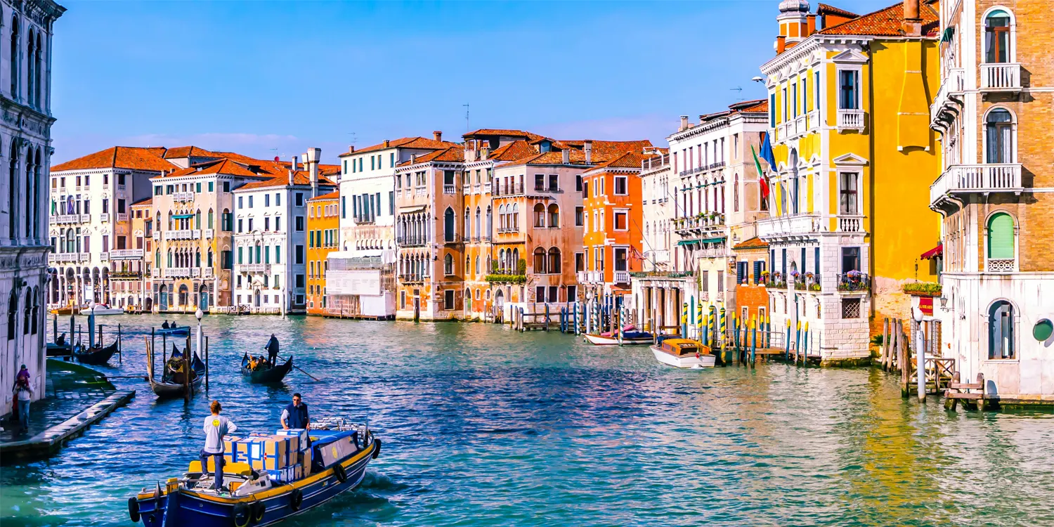 Colourful buildings on the side of a canal.